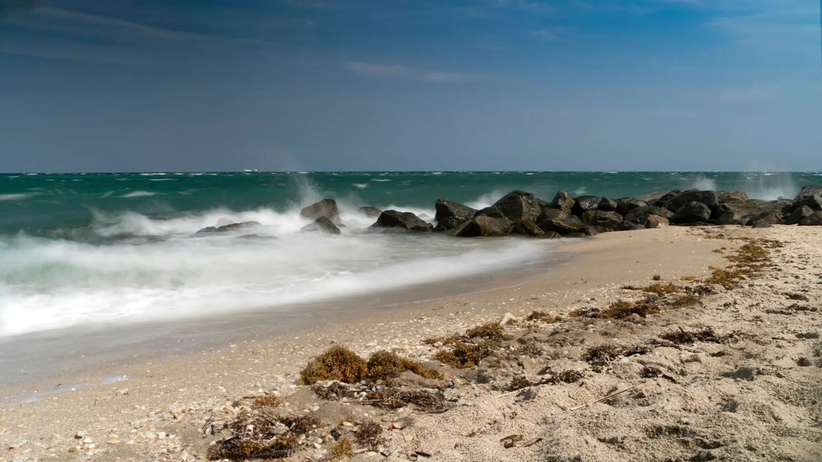 Waves breaking over a rock jetty on the Boynton Beach shoreline