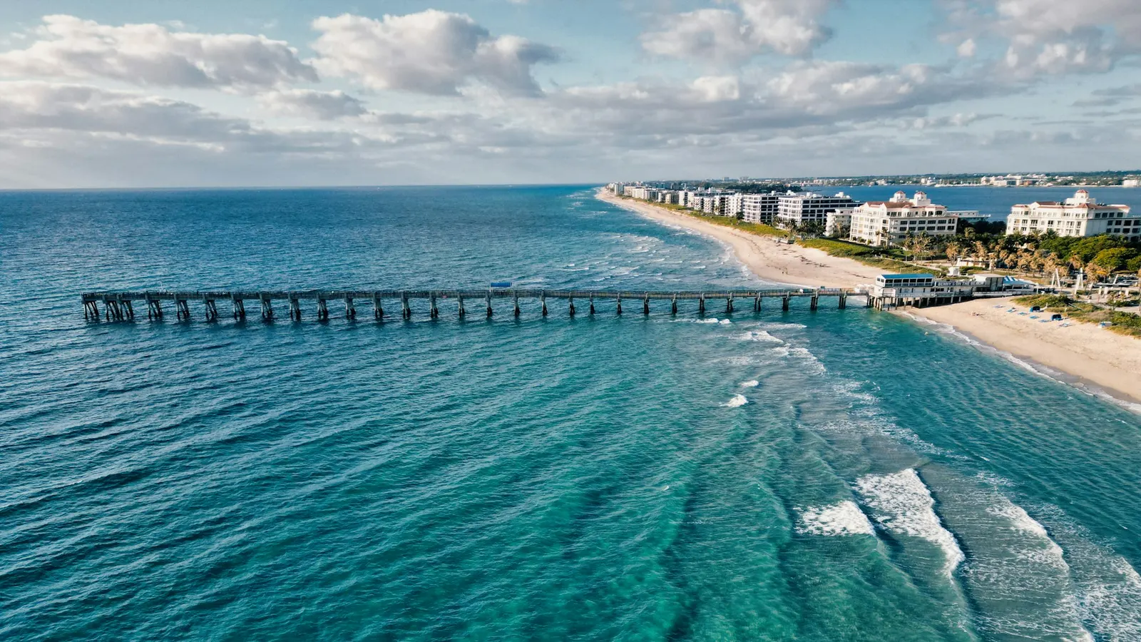 Long pier extending into the turquoise Atlantic at Lake Worth Beach